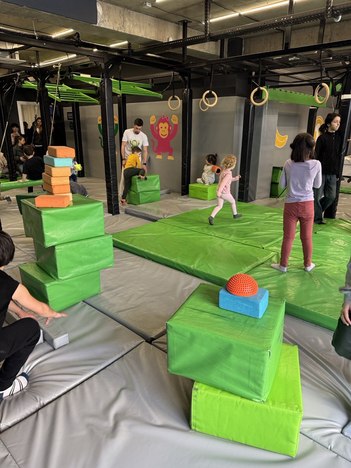 Small-group masterclass — children running an obstacle route together.