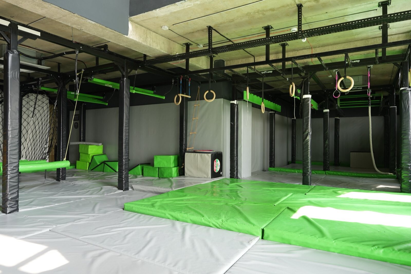 Children climbing on the Jungle Gym indoor obstacle course at Gymnasia in Tbilisi.